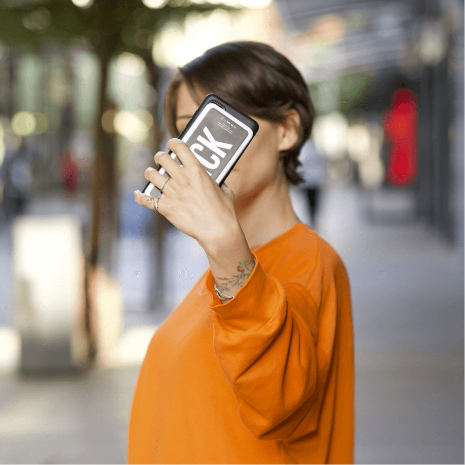 Girl taking a selfie while loading her phone with a Brick